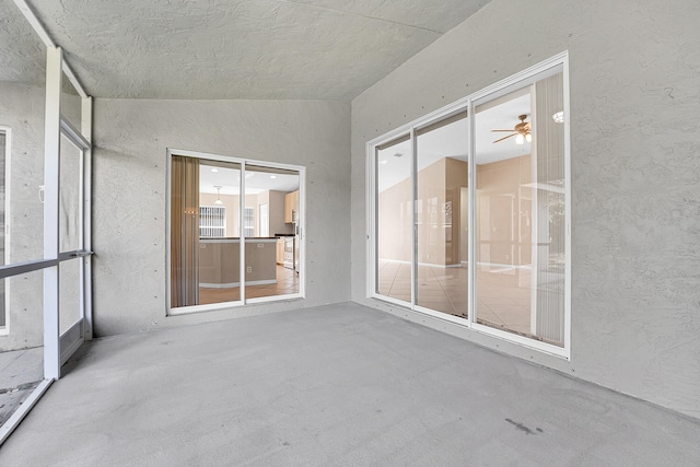 unfurnished sunroom with ceiling fan and lofted ceiling