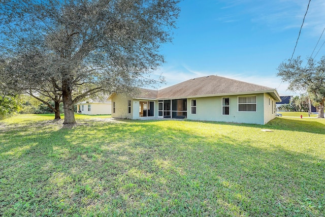 rear view of property with a lawn