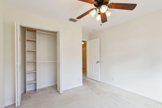 unfurnished bedroom featuring light colored carpet, a ceiling fan, baseboards, visible vents, and a closet