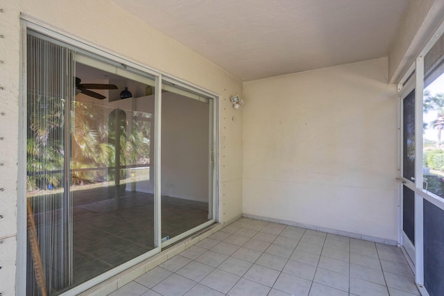 unfurnished sunroom featuring ceiling fan