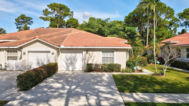 mediterranean / spanish-style home with a front yard and a garage