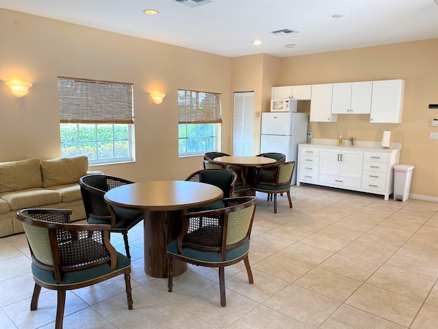 dining space featuring light tile patterned floors