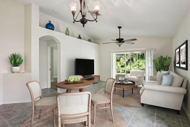 dining area featuring ceiling fan with notable chandelier and lofted ceiling