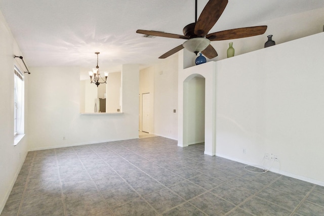 unfurnished room with ceiling fan with notable chandelier