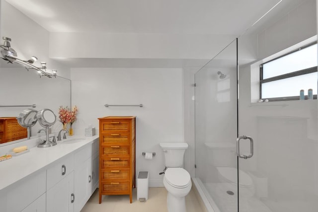 bathroom with vanity, toilet, and an enclosed shower