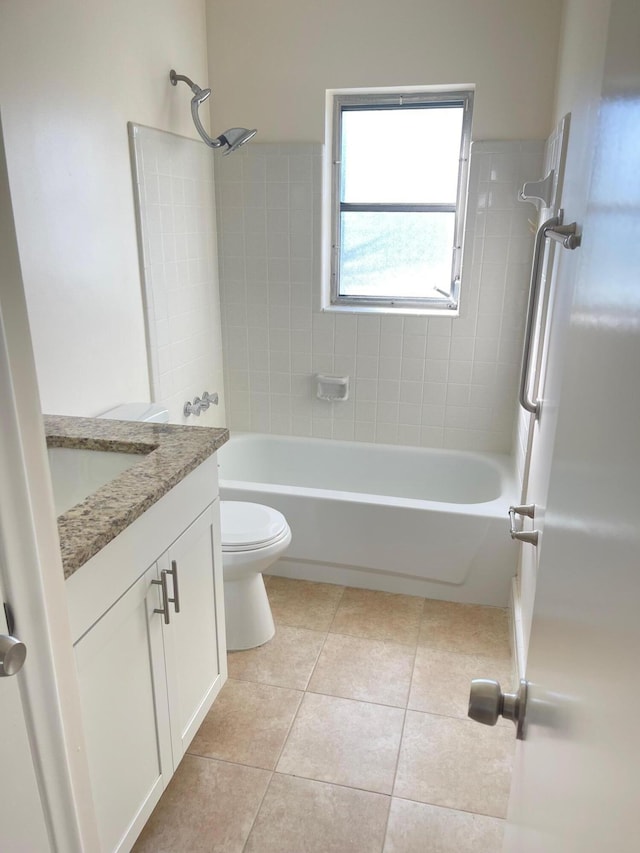 full bathroom with vanity, tiled shower / bath, tile patterned floors, and toilet