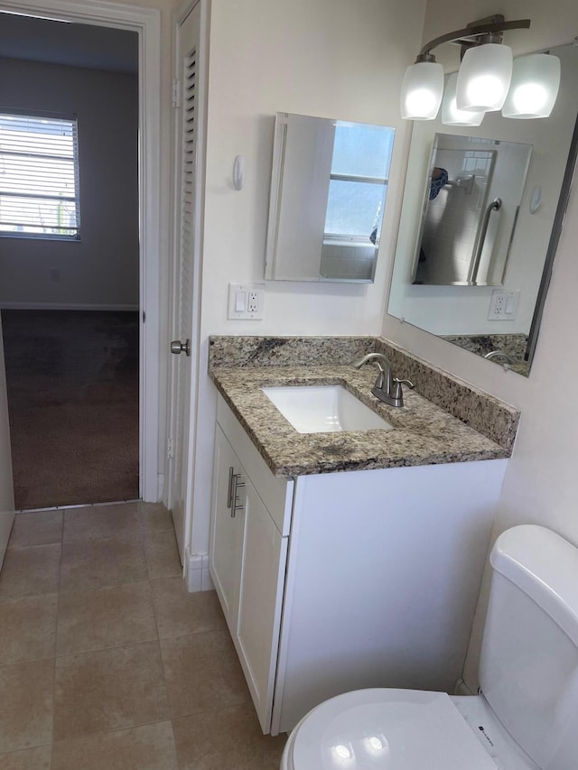 bathroom with vanity, tile patterned floors, and toilet