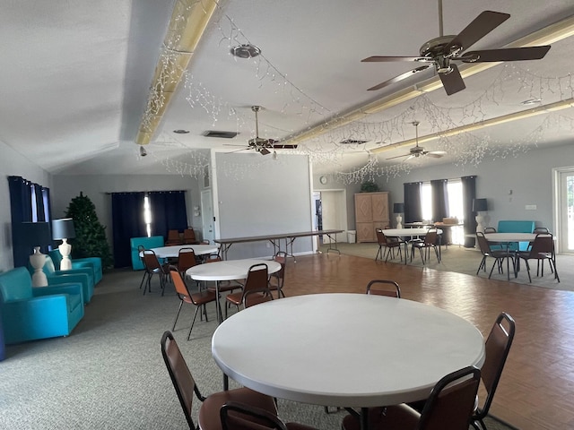 dining room featuring lofted ceiling with beams and light parquet flooring