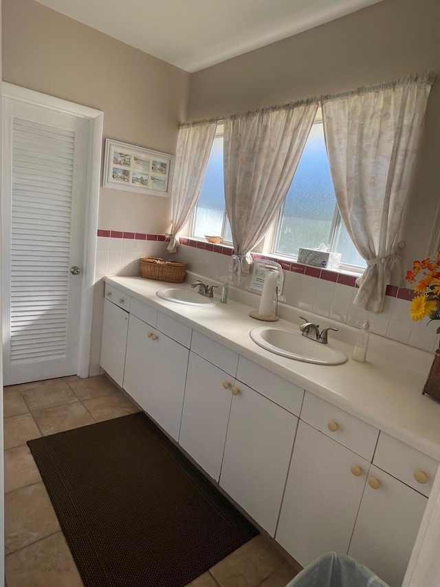 bathroom featuring tile patterned flooring, vanity, and backsplash