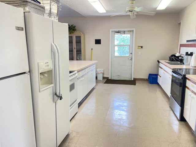 kitchen with white cabinetry, sink, white appliances, and ceiling fan