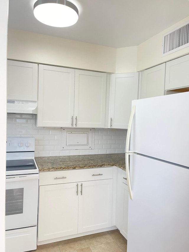 kitchen featuring white cabinetry, decorative backsplash, white appliances, and dark stone counters