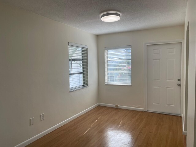 empty room with light hardwood / wood-style flooring