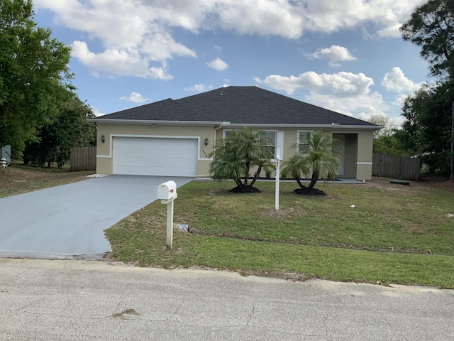 ranch-style home featuring an attached garage, fence, driveway, stucco siding, and a front yard