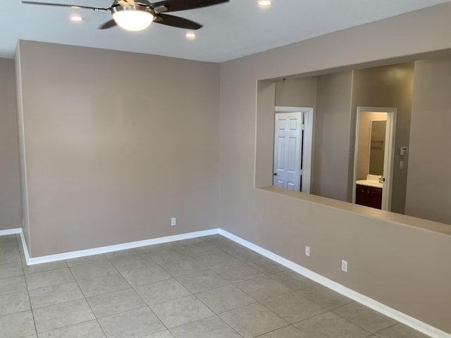 spare room with a ceiling fan, recessed lighting, light tile patterned flooring, and baseboards