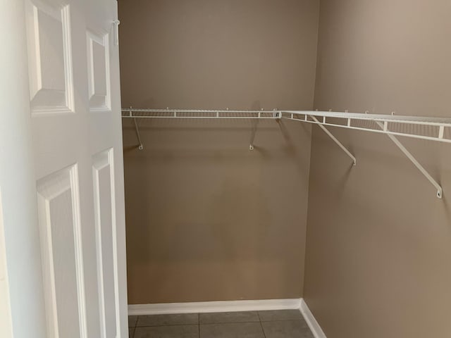 spacious closet featuring tile patterned flooring