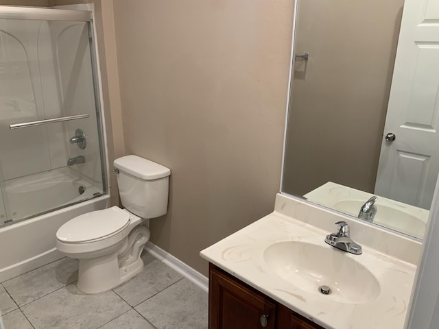 bathroom featuring toilet, enclosed tub / shower combo, vanity, baseboards, and tile patterned floors