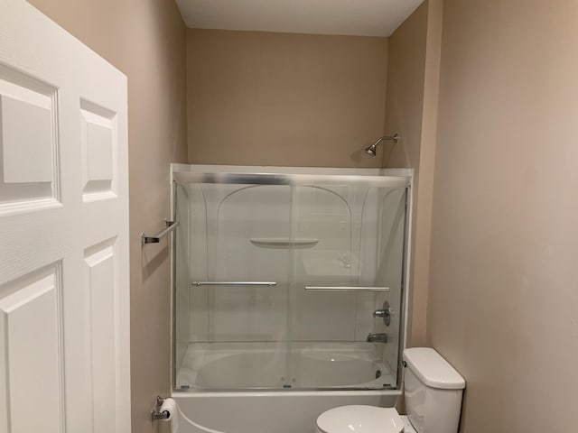 full bathroom with enclosed tub / shower combo and toilet