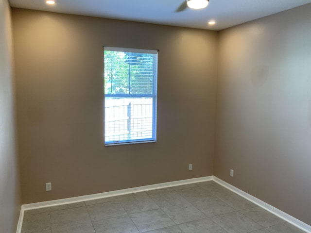 unfurnished room with recessed lighting and baseboards