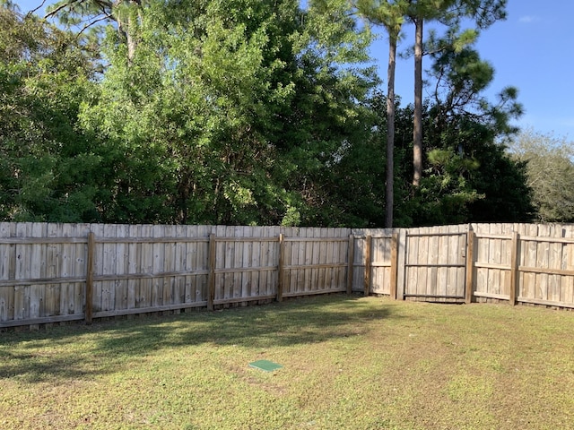 view of yard with a fenced backyard