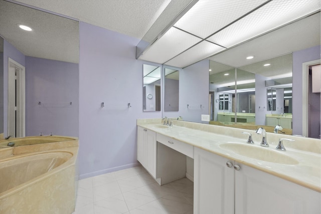 bathroom featuring a textured ceiling, vanity, tile patterned floors, and a bathing tub