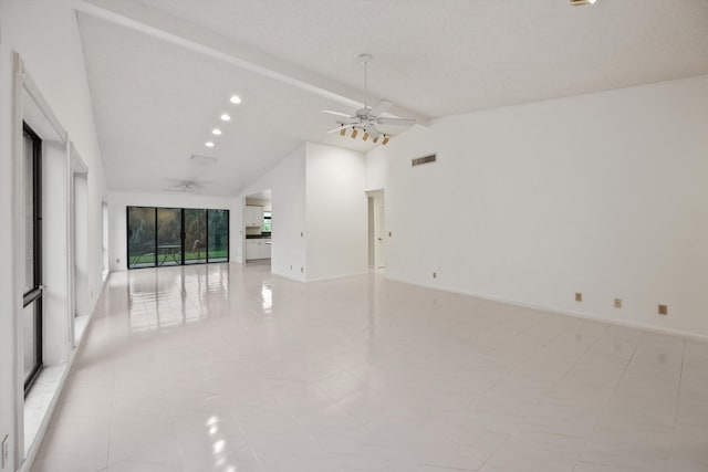 empty room featuring beamed ceiling, ceiling fan, and high vaulted ceiling