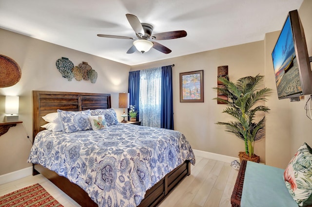 bedroom with ceiling fan and light hardwood / wood-style flooring