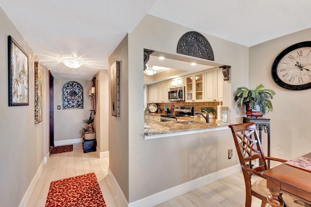 hall featuring sink and light hardwood / wood-style flooring