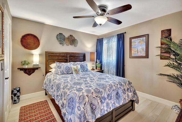 bedroom with light hardwood / wood-style floors and ceiling fan