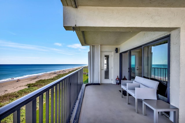 balcony featuring a view of the beach and a water view