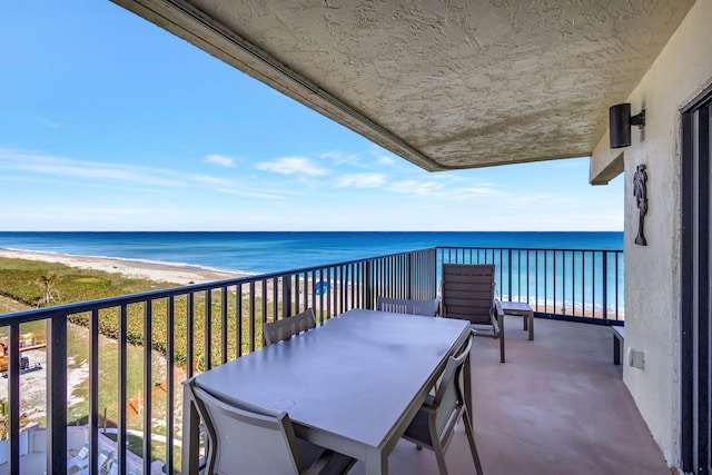 balcony with a beach view and a water view