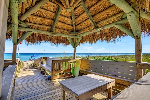 deck with a gazebo and a water view