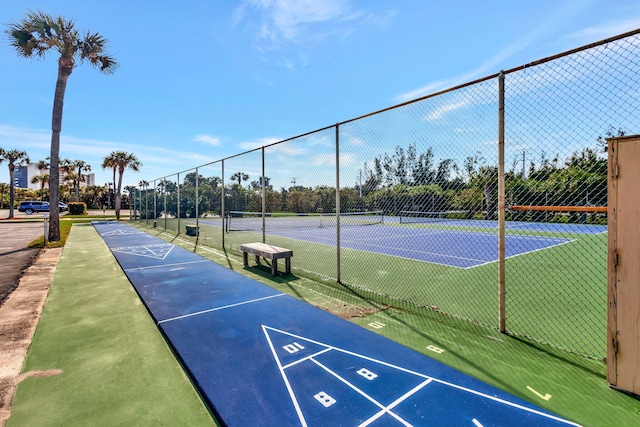 view of community featuring tennis court