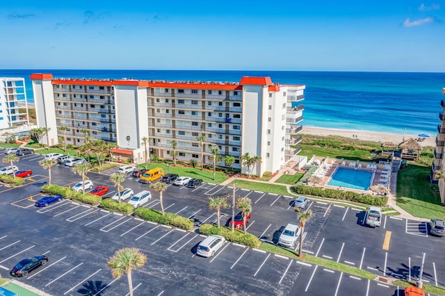 bird's eye view featuring a water view and a beach view