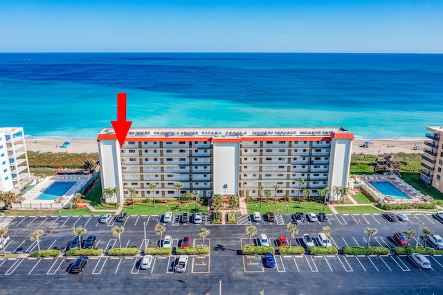 drone / aerial view featuring a view of the beach and a water view