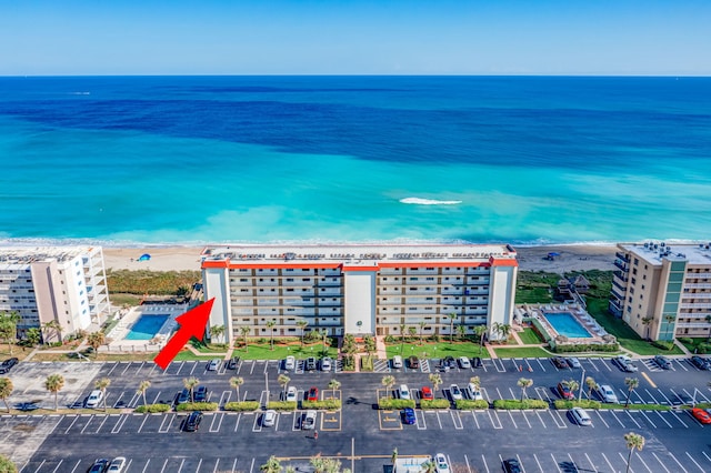 drone / aerial view with a beach view and a water view