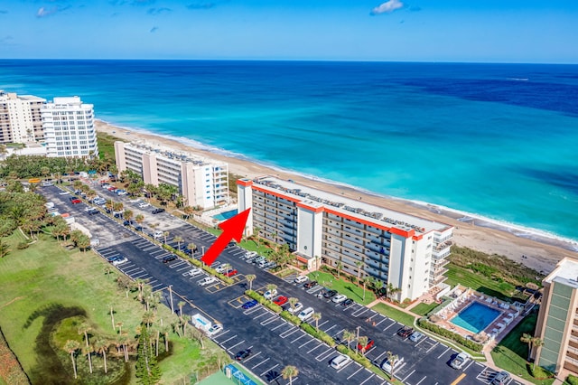 drone / aerial view featuring a water view and a beach view