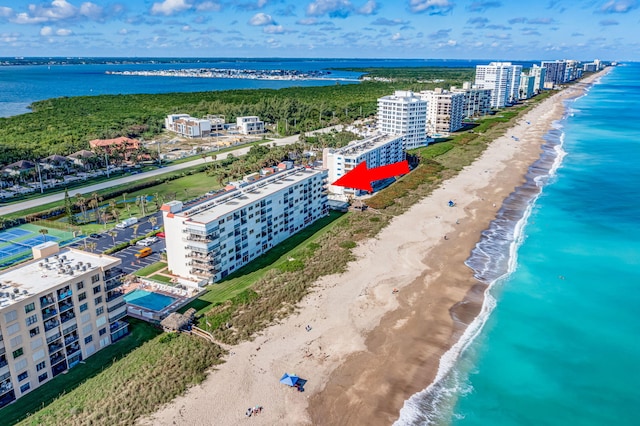 drone / aerial view with a water view and a view of the beach