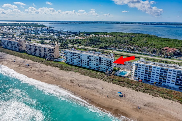 birds eye view of property featuring a beach view and a water view