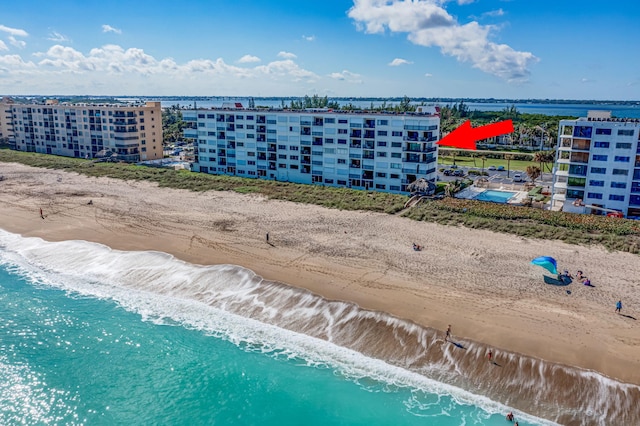 bird's eye view featuring a view of the beach and a water view