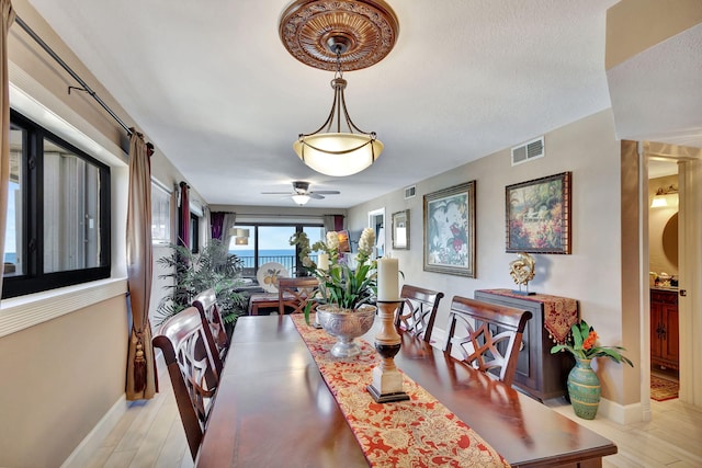 dining area featuring light hardwood / wood-style flooring and ceiling fan