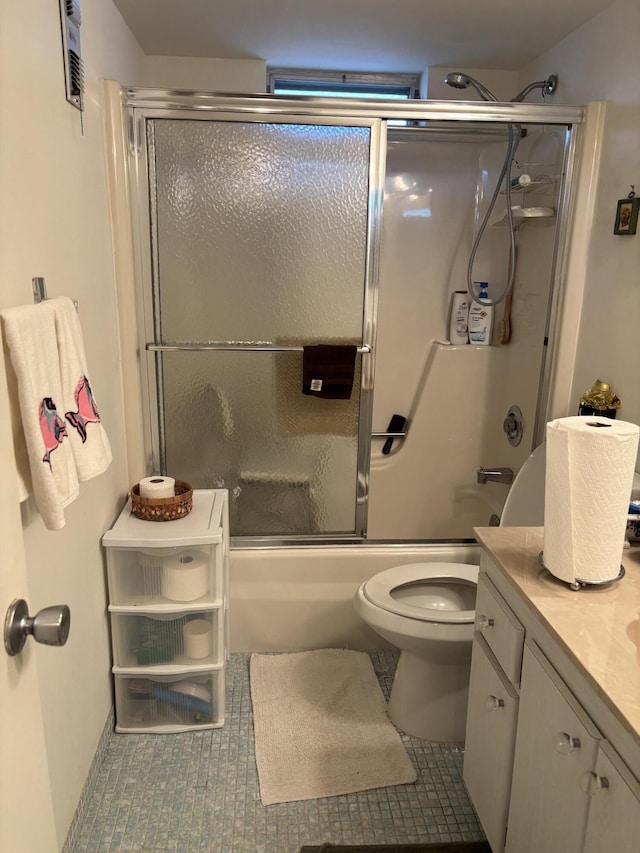 full bathroom with tile patterned flooring, vanity, toilet, and bath / shower combo with glass door