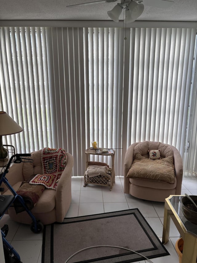 tiled living room with plenty of natural light and ceiling fan