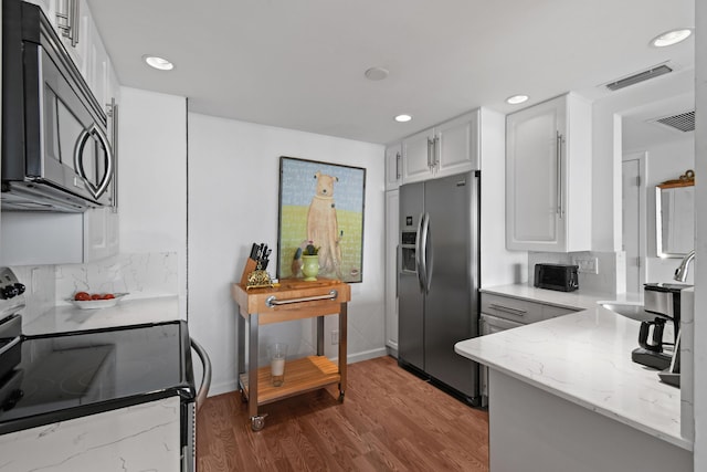 kitchen featuring white cabinetry, sink, electric range, stainless steel fridge, and wood-type flooring