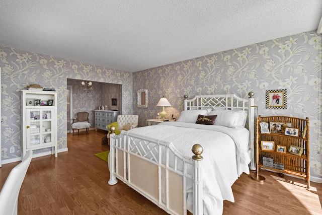 bedroom featuring a textured ceiling and dark hardwood / wood-style flooring