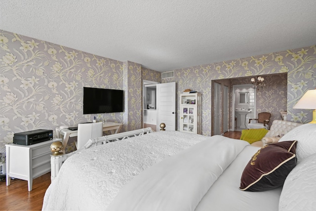 bedroom featuring a textured ceiling and hardwood / wood-style flooring