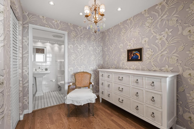 sitting room with a chandelier and dark hardwood / wood-style floors