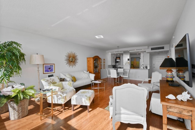 living room with hardwood / wood-style flooring and a textured ceiling