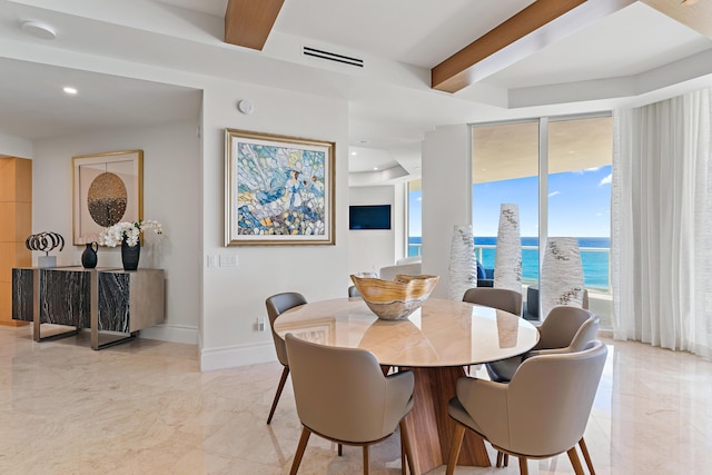 dining area with beamed ceiling