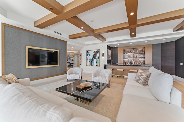 living room with beamed ceiling, bar, and coffered ceiling