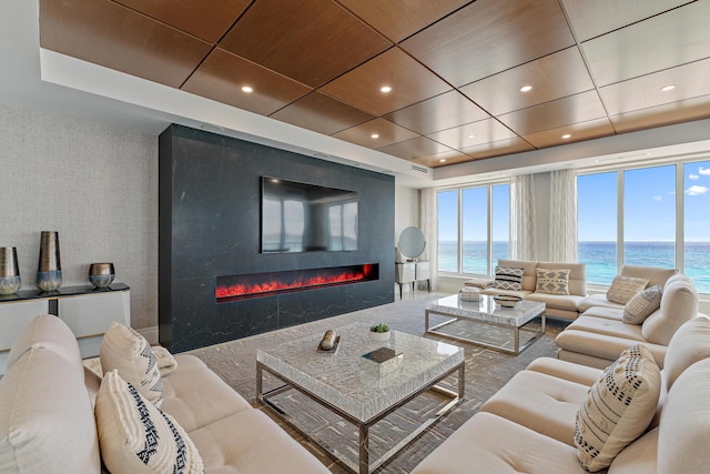 living room with a high end fireplace and wooden ceiling